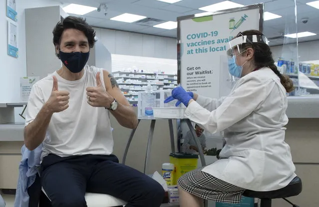 Prime Minister Justin Trudeau gives the thumbs up after receiving his COVID-19 AstraZeneca vaccination in Ottawa on Friday April 23, 2021. (Photo by Adrian Wyld/The Canadian Press via AP Photo)