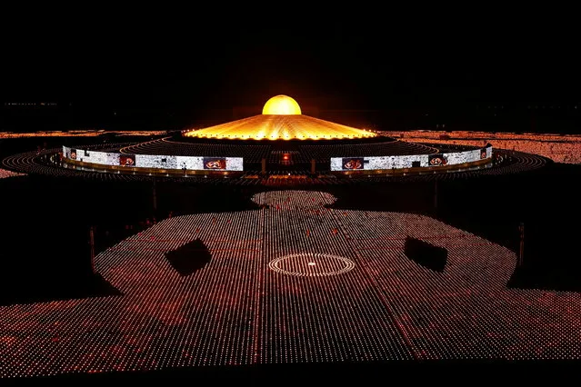 Buddhist monks of the Dhammakaya temple attend a meditation ceremony on Earth Day and light 330,000 candles arranged in the shape of the earth to set a Guinness World Record, in Pathum Thani province, Thailand on April 22, 2021. (Photo by Jorge Silva/Reuters)