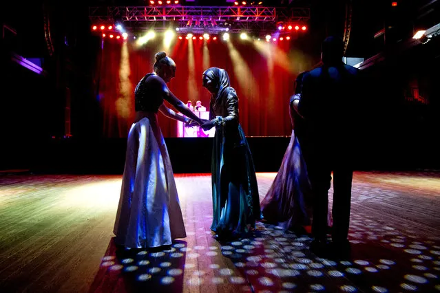 In this May 13, 2016, file photo, Samantha Bischoff, left, compliments Hannah Shraim on her prom dress during Northwest High School's senior prom at the Fillmore Theater in Silver Spring, Md. Senior class president and an observant Muslim, Shraim prays five times a day and hopes to become an advocate for Muslims in the United States. (Photo by Jacquelyn Martin/AP Photo)