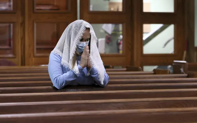 A churchgoer prays during Sunday mass at St. Joseph’s catholic church in Miami Beach on June 27, 2021. The apartment building partially collapsed on Thursday, June 24. (Photo by David Santiago/Miami Herald via AP Photo)