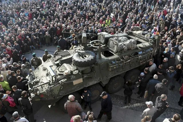People gather around an U.S. Army 2nd Cavalry Regiment “Stryker” armored fighting vehicle in Bialystok March 24, 2015, which is a part of the U.S. military “Dragoon Ride” operation. Dragoon Ride is aimed at demonstrating commitment to NATO allies in light of Russia's aggression in Ukraine, according to the U.S. Army. (Photo by Marcin Onufryjuk/Reuters/Agencja Gazeta)