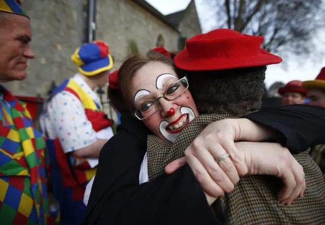 Clowns greet each other outside the All Saints Church before the Grimaldi clown service in Dalston, north London, February 7, 2016. (Photo by Peter Nicholls/Reuters)