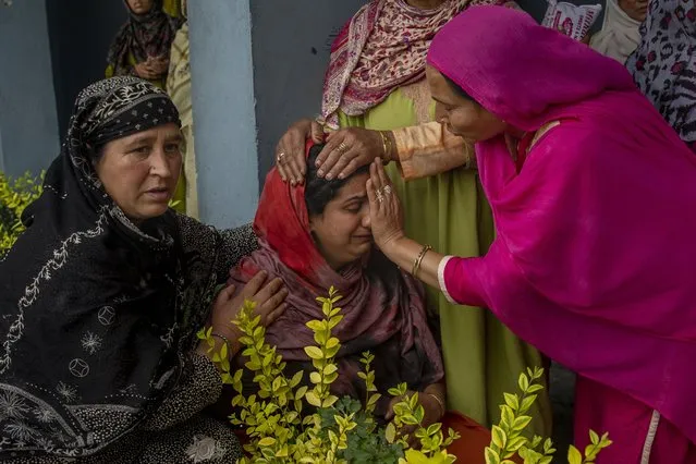 A Kashmiri villager cries beside her home that was destroyed in a gunfight after suspected rebels took refuge in it, in Pulwama, south of Srinagar, Indian controlled Kashmir, Wednesday, July 14, 2021. (Photo by Dar Yasin/AP Photo)