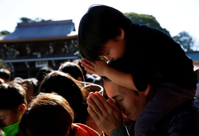 A man and a boy offer prayers on the first day of the new year at Meiji Shrine in Tokyo, Japan, January 1, 2017. (Photo by Kim Kyung-Hoon/Reuters)