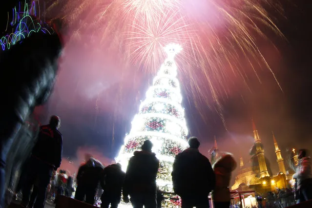 Fireworks explode over Martyrs Square during New Year's Day, in downtown Beirut, Lebanon, Tuesday, January 1, 2019. (Photo by Hassan Ammar/AP Photo)