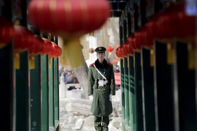 A paramilitary policeman stands guard as the Chinese Lunar New Year, which welcomes the Year of the Monkey, is celebrated at Daguanyuan park, in Beijing, China February 10, 2016. (Photo by Damir Sagolj/Reuters)