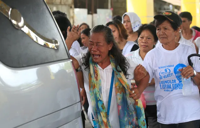 Maria Isabelita Espinosa, mother of teenager Sonny Espinosa, who according to the police is one of the seven people shot dead by suspected vigilantes at a house storing illegal narcotics, cries during her son’s funeral in Caloocan city, Metro Manila, Philippines January 8, 2017. (Photo by Romeo Ranoco/Reuters)