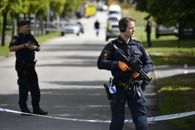 Police stand guard at the scene of an attack at a high school, in Eslov, Sweden, Thursday, August 19, 2021.  Police say a 15-year-old boy has been detained on suspicion of attempted murder after a school employee was seriously wounded in a knife attack in southern Sweden. The incident happened in Eslov, northeast of Malmo, Sweden’s third largest city. (Photo by Johan Nilsson/TT News Agency via AP Photo)