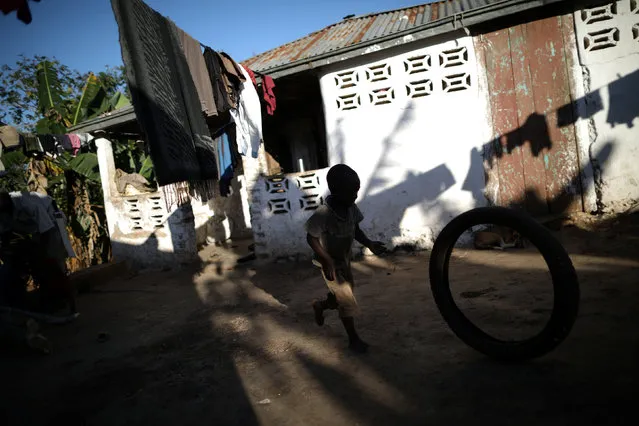 Romenson Exalus plays with a tire at his house in Boucan Ferdinand, Haiti, April 10, 2018. (Photo by Andres Martinez Casares/Reuters)