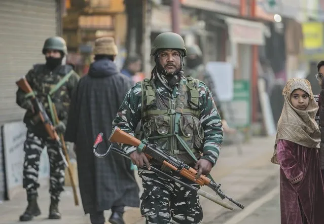 Indian paramilitary soldiers patrol a market in Srinagar, Indian controlled Kashmir,Tuesday, December 23, 2023. Anger spread in some remote parts of Indian-controlled Kashmir after three civilians were killed while in army custody, officials and residents said Saturday. This comes two days after a militant ambush killed four soldiers. (Photo by Mukhtar Khan/AP Photo)