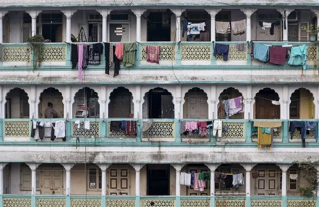 A resident locks the door of  an apartment of an old residential building in Mumbai January 28, 2015. The cost for buying a 240 square feet (22 square meters) one-bedroom apartment in this building is around 8,333 Indian rupees ($ 135) per square feet or 2,000,000 Indian rupees ($32,000). The rent for an apartment in the same building is around 10,000 Indian rupees ($ 160) per month. (Photo by Danish Siddiqui/Reuters)