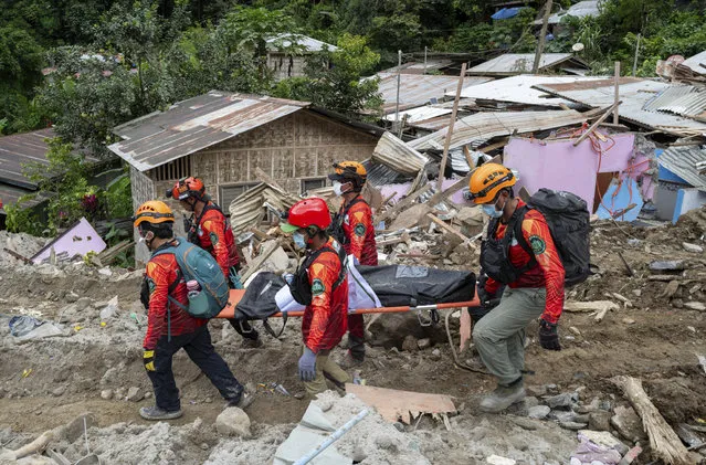Rescuers carry a body from the landslide-hit village of Masara in Maco, Davao de Oro province, southern Philippines on Thursday February 8, 2024. A landslide in the southern Philippines left a number of villagers dead and several others missing, including miners waiting in buses for a ride home, officials said Wednesday. (Photo by AP Photo)