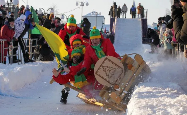 Participants fall while riding down a slope in a sled during Sunnyfest, an event exhibiting sleds constructed in an original and creative way, in Mamadysh town in the Republic of Tatarstan, Russia, on February 10, 2024. (Photo by Alexey Nasyrov/Reuters)