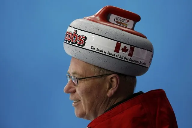 A fan of Canada wearing a hat in the shape of a stone looks on during their men's curling round robin game against Germany at the 2014 Sochi Olympics in the Ice Cube Curling Center in Sochi February 10, 2014. (Photo by Mark Blinch/Reuters)