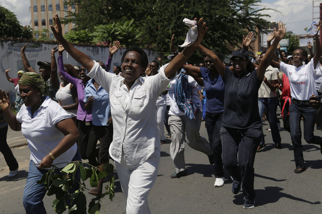 A group of over 250 women march through the center of Bujumbura, Burundi, calling for the release of protesters arrested during demonstrations, Sunday May 10, 2015. At least 13 people have died and 216 have been wounded in protests since April 25, when the ruling party announced it had nominated President Pierre Nkurunziza as its presidential candidate. (Photo by Jerome Delay/AP Photo)