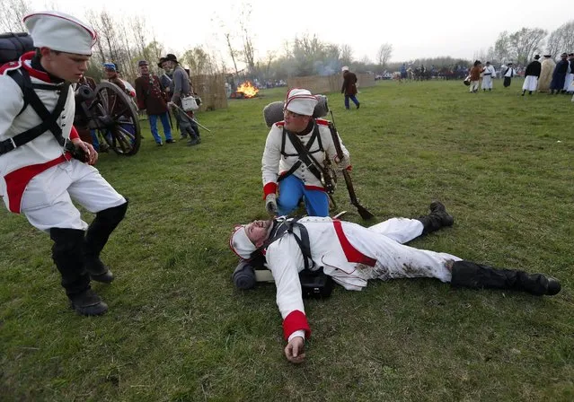 People dressed as Hungarian Hussars and Austrian soldiers of the Habsburg dynasty take part in the re-enactment of the battle of Tapiobicske, Hungary  April 4, 2016. (Photo by Laszlo Balogh/Reuters)