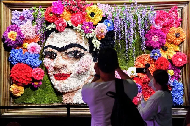 Visitors are seen as they interact with artwork during the opening of Frida Kahlo: The Life of an Icon, as part of the 2023 Sydney Festival, in Sydney, Australia, 04 January 2023. (Photo by Bianca De Marchi/EPA/EFE)