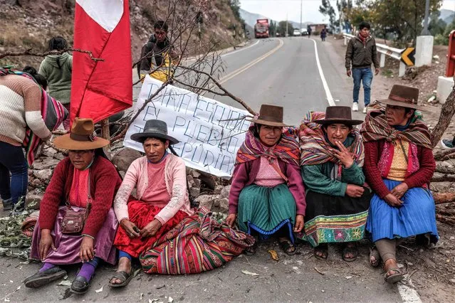 A placard reads “Dina, listen, the people reject you” as residents of the town of Huaro block the Cusco-Puno highway during an anti-government rally in Cusco, Peru, 04 January 2023. Massive protests resumed calling on the resignation of President Dina Boluarte, the release of former President Pedro Castillo, and early general elections. (Photo by Aldair Mejia/EPA/EFE/Rex Features/Shutterstock)