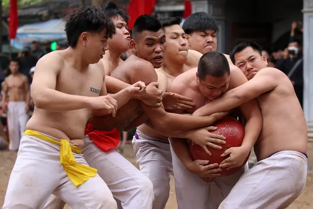 Local villagers of the Hoang Mai district fight for the ball made of jackfruit wooden, weighing 25kg during the Thuy Linh village traditional ball scrambling festival, in Hanoi, Vietnam, 15 February 2024. The festival which is held on the first week of every first lunar month have attracted hundreds of visitors. (Photo by Luong Thai Linh/EPA)