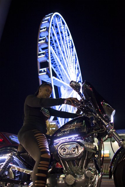 A biker sis in traffic by the Myrtle Beach SkyWheel on Ocean Boulevard during the 2015 Atlantic Beach Memorial Day BikeFest in Myrtle Beach, South Carolina May 24, 2015. (Photo by Randall Hill/Reuters)