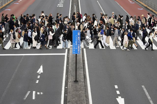 Passersby cross a large street at Shinjuku's business and shopping district in Tokyo, Japan, 12 April 2024. According to data released on 12 April by the Ministry of Internal Affairs and Communications, Japan's total population including foreigners as of 01 October 2023 decreased by 595,000 (0.48 percent) from the previous year to 124,352,000, the 13th consecutive year of decline. The number of Japanese citizens decreased by 837,000 (0.69 percent) to 121,193,000, marking the largest demographic decline since 1950. (Photo by Franck Robichon/EPA)