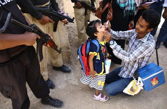 Police guard Polio vaccination team, a day after seven policemen who were on security duty to Polio vaccination team were killed by unknown gunmen in Karachi, during a three-day vaccination campaign in Karachi, Pakistan, 21 April 2016. Pakistan is one of the last two countries – along with Afghanistan – where the polio is still endemic, meaning infections occur within the local population or within a particular area. (Photo by Shahzaib Akber/EPA)