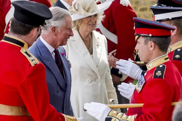 Britain's Prince Charles and Camilla, the Duchess of Cornwall, speak with the troops during a ceremony for the opening of the Hougoumont farm as part of the bicentennial celebrations for the Battle of Waterloo, near Waterloo, Belgium June 17, 2015. The commemorations for the 200th anniversary of the Battle of Waterloo will take place in Belgium on June 19 and 20. REUTERS/Geert Vanden Wijngaert/Pool
