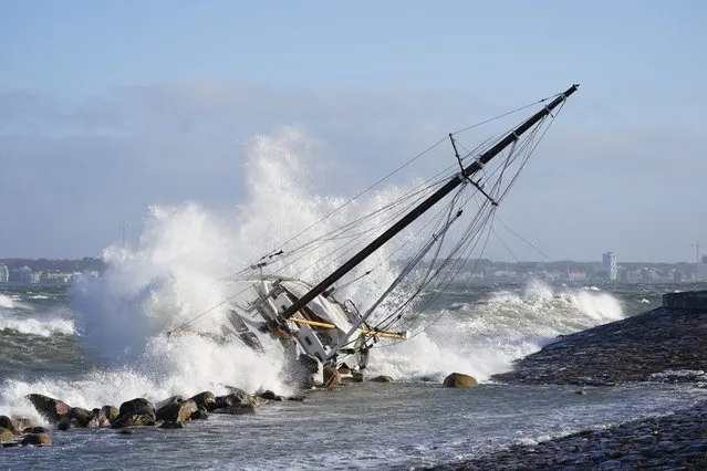 Waves crash against a sailboat in Elsinore, Denmark, Sunday January 30, 2022, after a large winter storm caused havoc in Scandinavia with tens of thousands of people without electricity, trees uprooted and bridges closed. (Photo by Keld Navntoft/Ritzau Scanpix via AP Photo)