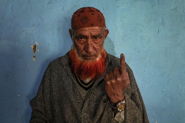 A man shows ink mark on his finger after casting his vote during the fourth phase of India's general election in Baba Nagri, northeast of Srinagar, Indian controlled Kashmir, Monday, May 13, 2024. (Photo by Dar Yasin/AP Photo)