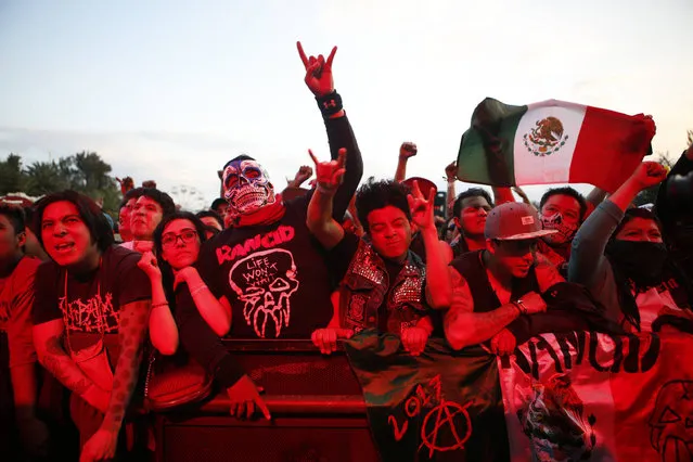 Fans bathed in red light cheer on Mexican metal band Brujeria during Vive Latino in Mexico City, Sunday, March 19, 2017. The Vive Latino Festival has become Latin America's biggest Latin rock celebration. (Photo by Rebecca Blackwell/AP Photo)
