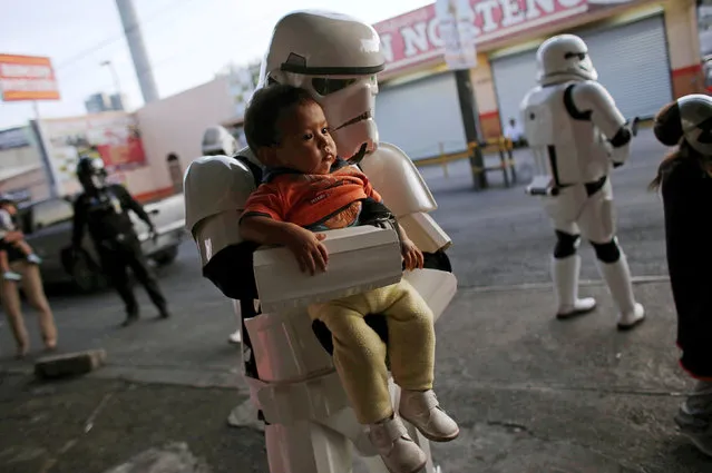 A member of the Star Wars fan club, dressed as a Stormtrooper, poses for a photo with a girl outside a hospital's emergency ward during Star Wars Day celebrations in Monterrey, Mexico May 4, 2016. (Photo by Daniel Becerril/Reuters)