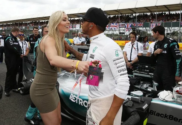 Formula One, British Grand Prix 2015 – Silverstone, England on July 5, 2015: Skier Lindsey Vonn kisses Mercedes' Lewis Hamilton before the race. (Photo by Phil Noble/Reuters)