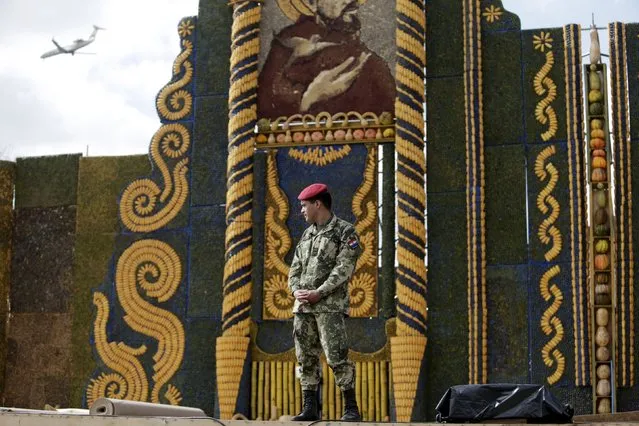 A soldier guards an altar, made of corn and pumpkins, where Pope Francis will give the main mass on July 12 during his visit to Paraguay, July 9, 2015. (Photo by Jorge Adorno/Reuters)