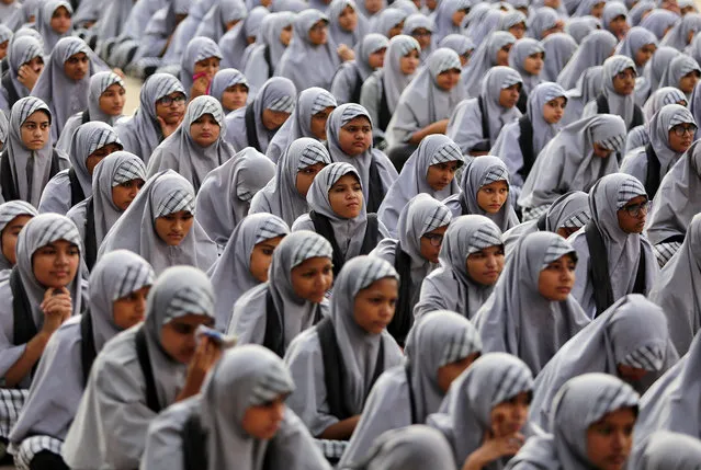 School girls listen to their teacher (not pictured) during a lecture on the Article 370, a special constitutional status for Kashmir which was scrapped by the Indian government last month, to mark Prime Minister Narendra Modi's birthday at a school in Ahmedabad, India, September 17, 2019. (Photo by Amit Dave/Reuters)