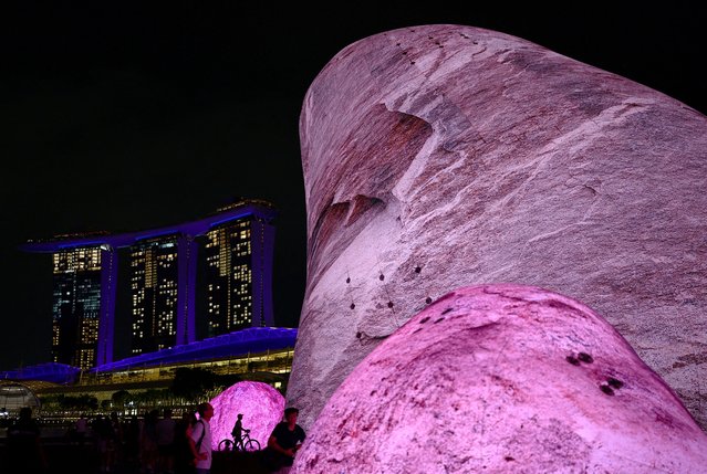 People interact with the Iwagumi Air Scape light art installation by Australian studio ENESS during the i Light Festival at the Marina Bay in Singapore on June 13, 2024. (Photo by Edgar Su/Reuters)