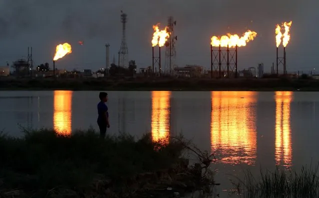 Flames emerge from flare stacks at Nahr Bin Umar oil field, north of Basra, Iraq September 16, 2019. (Photo by Essam Al-Sudani/Reuters)