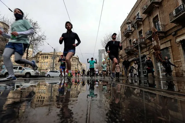 Runners take part in the Jerusalem Marathon which includes international competitors, after Israel eased coronavirus disease (COVID-19) restrictions on tourists entering the country, in Jerusalem March 25, 2022. (Photo by Ammar Awad/Reuters)
