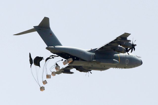 Humanitarian aid packages land with the help of parachutes after being dropped from a plane as Israeli attacks continue in Gaza City, Gaza on May 23, 2024. (Photo by Ashraf Amra/Anadolu via Getty Images)