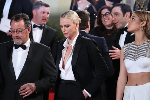 Actor Jean Reno (L) , actress Charlize Theron (C)  and actress Adele Exarchopoulos leave “The Last Face” Premiere during the 69th annual Cannes Film Festival at the Palais des Festivals on May 20, 2016 in Cannes, France. (Photo by Andreas Rentz/Getty Images)
