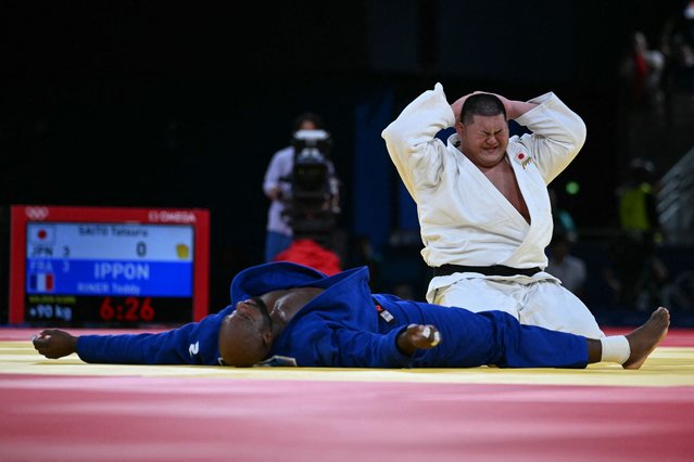 Japan's Tatsuru Saito reacts after loosing to France's Teddy Riner (Blue) in the judo mixed team gold medal bout between Japan and France at the Paris 2024 Olympic Games in the Champ-de-Mars Arena, in Paris on August 3, 2024. (Photo by Luis Robayo/AFP Photo)