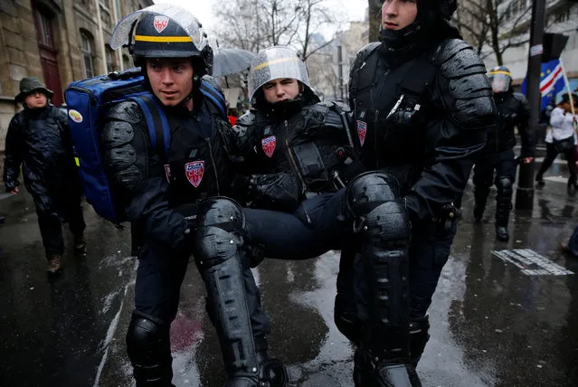 A French CRS riot police is evacuated during clashes with French high school and university students during a demonstration against the French labour law proposal in Paris, France, as part of a nationwide labor reform protests and strikes, March 31, 2016. (Photo by Benoit Tessier/Reuters)