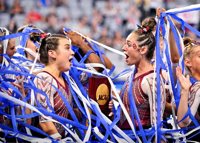 The Oklahoma Sooners gymnastic team celebrates with the NCAA national championship trophy and confetti after coming in first place in the 2022 NCAA women's gymnastics championship at Dickies Arena in Fort Worth, TX. on April 16, 2022. (Photo by Jerome Miron/USA TODAY Sports)