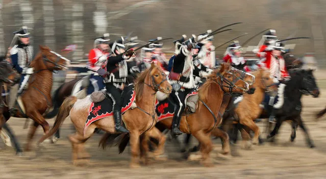 People dressed in the historic uniforms of the Imperial Russian and French armies take part in a re-enactment of the 1812 Battle of Berezina, to mark the 207th anniversary of the battle, near the village of Bryli, Belarus on November 24, 2019. (Photo by Vasily Fedosenko/Reuters)