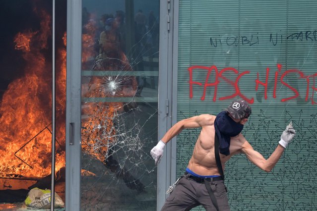 A protester clashes with police during a commemoration march for a teenage driver shot dead by a policeman, in the Parisian suburb of Nanterre, on June 29, 2023. Violent protests broke out in France in the early hours of June 29, 2023, as anger grows over the police killing of a teenager, with security forces arresting 150 people in the chaos that saw balaclava-clad protesters burning cars and setting off fireworks. Nahel M., 17, was shot in the chest at point-blank range in Nanterre in the morning of June 27, 2023, in an incident that has reignited debate in France about police tactics long criticised by rights groups over the treatment of people in low-income suburbs, particularly ethnic minorities. (Photo by Alain Jocard/AFP Photo)