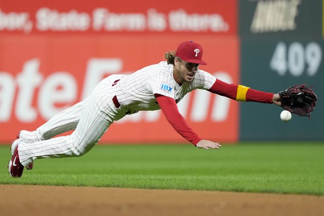 Philadelphia Phillies second baseman Bryson Stott cannot reach a single by Chicago Cubs' Mike Tauchman during the sixth inning of a baseball game Monday, September 23, 2024, in Philadelphia. (Photo by Matt Slocum/AP Photo)