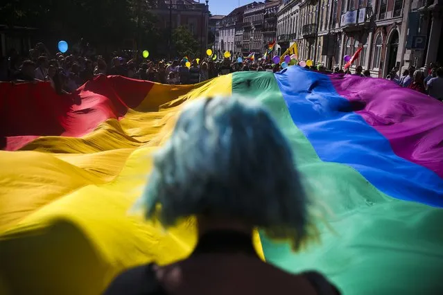 People take part in the 17th Lisbon gay pride parade against the discrimination of lesbian, gay, bisexual, and transgender (LGBT) people, in Lisbon, Portugal, 18 June 2016. (Photo by Mario Cruz/EPA)