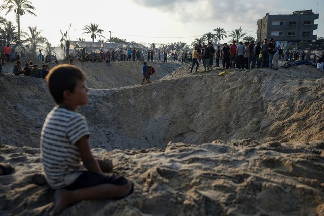 Palestinians look at the destruction after an Israeli airstrike on a crowded tent camp housing Palestinians displaced by the war in Muwasi, Gaza Strip, Tuesday, September 10, 2024. An Israeli strike killed at least 40 people and wounded 60 others early Tuesday, Palestinian officials said. Israel said it targeted “significant” Hamas militants, allegations denied by the militant group. (Photo by Abdel Kareem Hana/AP Photo)