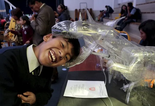 A student jokes with a dinosaur robot built with recycled materials during the annual robotics fair supported by the Bolivian Education Ministry in La Paz, August 10, 2015. (Photo by David Mercado/Reuters)