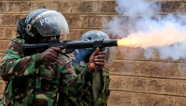 A riot police officer fires tear gas supporters of Kenya's opposition leader Raila Odinga of the Azimio La Umoja (Declaration of Unity) One Kenya Alliance, participate in an anti-government protest against the imposition of tax hikes by the government in Nairobi, Kenya on July 19, 2023. (Photo by Thomas Mukoya/Reuters)