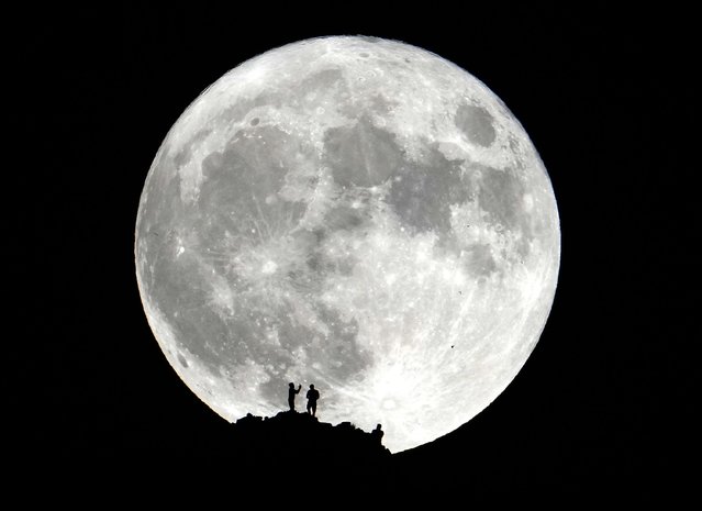 Hikers watch the Super Blue Moon from the summit of Piestewa Peak in Phoenix on August 30, 2023. (Photo by Rob Schumacher/The Arizona Republic via USA Today Network)